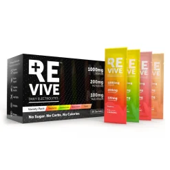 A box labelled REVIVE Electrolytes with four sachets—raspberry, lemon lime, watermelon, and peach—beside it. The box highlights sodium, potassium, magnesium electrolytes and contains zero sugar or calories.