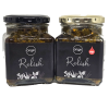 Two jars of Origin Relish with black labels and metal lids—one black, one gold. The right jar reads HOT with a red chilli icon; the left has no spice marking.